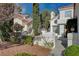 Charming two-story home featuring a red tile roof and lush front yard landscaping at 2864 Cape Verde Ln, Las Vegas, NV 89128