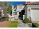 Charming two-story home featuring a red tile roof and lush front yard landscaping at 2864 Cape Verde Ln, Las Vegas, NV 89128