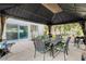 Gazebo features an outdoor dining set and curtains for privacy and style at 2864 Cape Verde Ln, Las Vegas, NV 89128