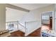 Hallway featuring hardwood floors and white railing overlooking the living room at 2864 Cape Verde Ln, Las Vegas, NV 89128