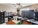 Hardwood floors and a ceiling fan feature in this furnished home office at 2864 Cape Verde Ln, Las Vegas, NV 89128