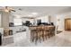 Bright kitchen features white cabinetry, black countertops, and a breakfast bar with seating for casual dining at 2864 Cape Verde Ln, Las Vegas, NV 89128