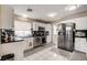 Kitchen with stainless appliances, black granite counters, and crisp white cabinets and drawers at 2864 Cape Verde Ln, Las Vegas, NV 89128