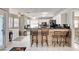 Bright open kitchen with bar seating, white cabinets, and modern appliances at 2864 Cape Verde Ln, Las Vegas, NV 89128