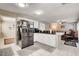 Open kitchen with stainless steel appliances, white cabinetry, and black countertops at 2864 Cape Verde Ln, Las Vegas, NV 89128