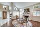 Cozy living room featuring a fireplace, large windows, and hardwood floors at 2864 Cape Verde Ln, Las Vegas, NV 89128