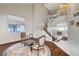 Bright living room featuring high ceilings, elegant staircase, and warm hardwood floors at 2864 Cape Verde Ln, Las Vegas, NV 89128