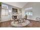 Cozy living room featuring a fireplace, large windows, and hardwood floors at 2864 Cape Verde Ln, Las Vegas, NV 89128