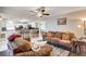 Comfortable living area with open access to a modern kitchen and ceiling fan at 2864 Cape Verde Ln, Las Vegas, NV 89128