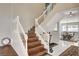 Staircase with wood stairs and white railing leading to a tiled dining area at 2864 Cape Verde Ln, Las Vegas, NV 89128