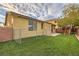 Backyard with artificial grass, chainlink fence, block wall, and playhouse at 10632 Open Range Ct, Las Vegas, NV 89179
