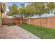 Backyard featuring a playhouse on artificial grass and brick pavers at 10632 Open Range Ct, Las Vegas, NV 89179