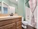 Bathroom with a granite countertop vanity, shower with curtain, and tile floor at 10632 Open Range Ct, Las Vegas, NV 89179