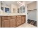 A bathroom with a double vanity, wood cabinets, and a vanity mirror at 10632 Open Range Ct, Las Vegas, NV 89179
