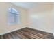 Bright bedroom with hardwood flooring and a large window with blinds at 10632 Open Range Ct, Las Vegas, NV 89179