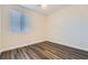 Cozy bedroom featuring wood flooring, modern blinds, and neutral paint at 10632 Open Range Ct, Las Vegas, NV 89179