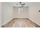 Modern bedroom featuring wood laminate flooring and ample natural light at 10632 Open Range Ct, Las Vegas, NV 89179