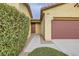 Close-up of home featuring concrete walkway to the front door, and a two-car garage on the right at 10632 Open Range Ct, Las Vegas, NV 89179