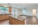 A kitchen with an island with granite countertops, dark wood cabinets, and stainless steel appliances at 10632 Open Range Ct, Las Vegas, NV 89179