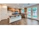 Bright kitchen featuring an island, granite countertops, stainless appliances, and doors to the backyard at 10632 Open Range Ct, Las Vegas, NV 89179