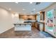 A kitchen with stainless steel appliances, granite countertops, an island, and tile floors at 10632 Open Range Ct, Las Vegas, NV 89179