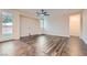 Open-concept living room featuring wood laminate flooring and natural light from the adjacent yard at 10632 Open Range Ct, Las Vegas, NV 89179