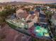 Expansive backyard with a sparkling pool, spa, covered patio, and outdoor kitchen at 1168 Spago Ln, Henderson, NV 89052