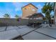 Stylish backyard patio featuring an outdoor dining area, a lush tree, and contemporary hardscaping at 1168 Spago Ln, Henderson, NV 89052