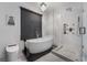 Bathroom featuring a modern tub, glass-enclosed shower, dark accents and bright lighting at 1168 Spago Ln, Henderson, NV 89052