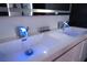 Bathroom featuring dual sinks with light-up faucets and white cabinets at 1168 Spago Ln, Henderson, NV 89052