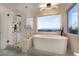 This modern bathroom features a sleek glass shower, soaking tub, and designer fixtures at 1168 Spago Ln, Henderson, NV 89052