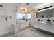 Spa-like bathroom featuring double vanities, a soaking tub, and stylish tile work at 1168 Spago Ln, Henderson, NV 89052