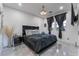 Bedroom with large bed, dark accents, light gray flooring and multiple windows at 1168 Spago Ln, Henderson, NV 89052
