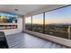 Enjoy spectacular city views from this bedroom with floor-to-ceiling windows and a cozy fireplace at 1168 Spago Ln, Henderson, NV 89052