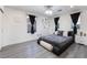 This bright bedroom showcases clean lines, modern decor, and large windows for ample natural light at 1168 Spago Ln, Henderson, NV 89052