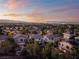 Neighborhood view with mature trees, tile roofs, and mountain views at 1168 Spago Ln, Henderson, NV 89052