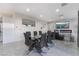 Modern dining area with a glass table, stylish chairs, and a feature wall with a fireplace at 1168 Spago Ln, Henderson, NV 89052