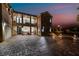 Elegant two-story home with a stone facade, multiple balconies, and a spacious paved driveway at 1168 Spago Ln, Henderson, NV 89052