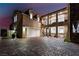 Stunning modern home with multiple balconies, lush landscaping, and a spacious driveway at 1168 Spago Ln, Henderson, NV 89052