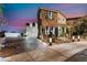 Beautiful two-story home with a stone facade, arched entryway, and landscaped front yard at 1168 Spago Ln, Henderson, NV 89052