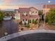 Charming home featuring stone accents, a tile roof, a well-manicured front yard and driveway at 1168 Spago Ln, Henderson, NV 89052