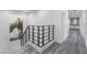 Hallway with light wood flooring, metal stair railing and white walls at 1168 Spago Ln, Henderson, NV 89052