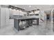 A spacious kitchen featuring a large island with barstool seating and modern finishes at 1168 Spago Ln, Henderson, NV 89052