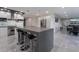 A spacious kitchen with a center island, bar seating, and stainless steel appliances at 1168 Spago Ln, Henderson, NV 89052
