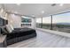 Main bedroom with bed, fireplace, tv, and large windows displaying the outdoor view at 1168 Spago Ln, Henderson, NV 89052