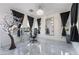 Bright office space with a decorative chandelier, gray tile flooring, multiple windows and dark accents at 1168 Spago Ln, Henderson, NV 89052