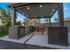 Outdoor kitchen complete with stainless steel appliances and bar seating, ideal for al fresco dining at 1168 Spago Ln, Henderson, NV 89052