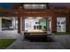 Outdoor patio featuring a central fire pit, hanging chair, tiled patio and sliding doors at 1168 Spago Ln, Henderson, NV 89052