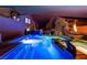 Inviting pool and hot tub area beautifully lit at night, offering a relaxing and luxurious outdoor experience at 1168 Spago Ln, Henderson, NV 89052