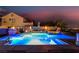 Beautiful backyard pool illuminated at dusk, boasting a serene ambiance with decorative statues and fire features at 1168 Spago Ln, Henderson, NV 89052